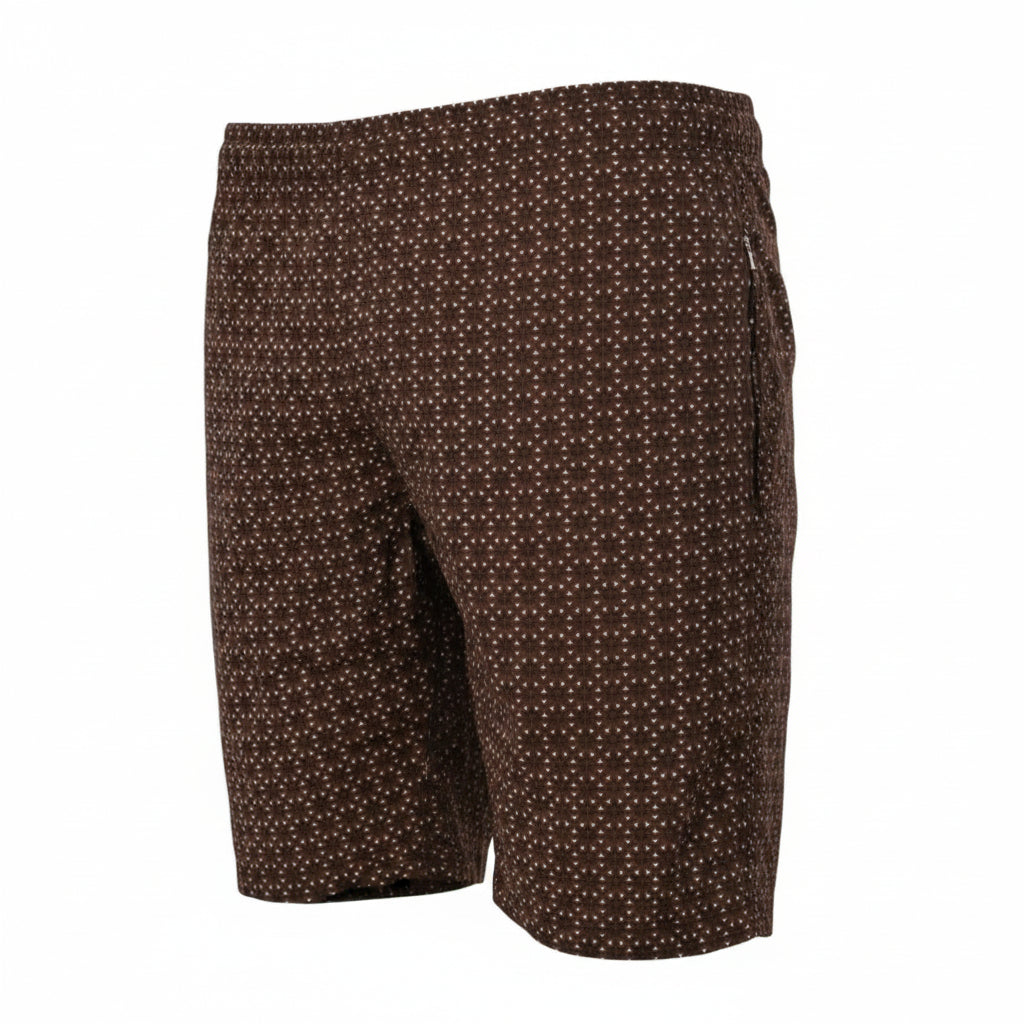 A rear three-quarter ghost mannequin product photograph of dark brown men's swim shorts featuring a dense white geometric micro-pattern. The image highlights a secure zipper pocket on the right side and an elastic waistband, set against a seamless white background. (Style: Ghost Mannequin view)