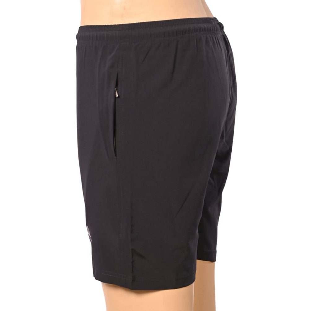 The primary goal is to remove the mannequin entirely and present the garment as if it is floating, seamlessly filled by an invisible form. This requires reconstructing the side of the pants where the arm is resting, completing the waistband, and ensuring all product details (like the red stripe and logo) are sharp.