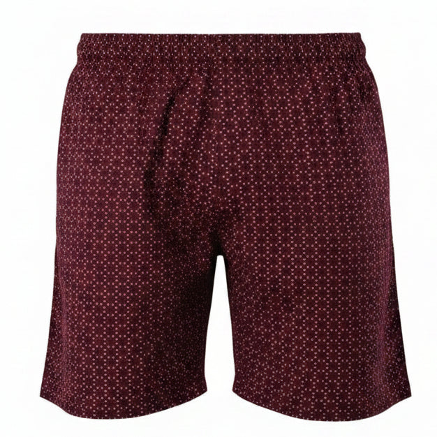 A front-facing professional ghost mannequin product photograph of men's deep maroon swim shorts featuring a dense white geometric micro-pattern and an elastic waistband, set against a seamless white studio background. (Style: Ghost Mannequin view)