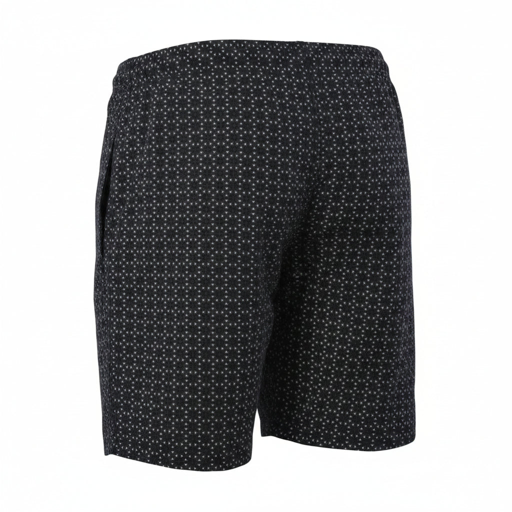 A rear three-quarter ghost mannequin product photograph of Blend men's navy blue swim shorts with a white geometric micro-pattern. The image highlights an elastic waistband and a secure zipper pocket on the right hip, floating against a seamless white background. (Style: Ghost Mannequin view)