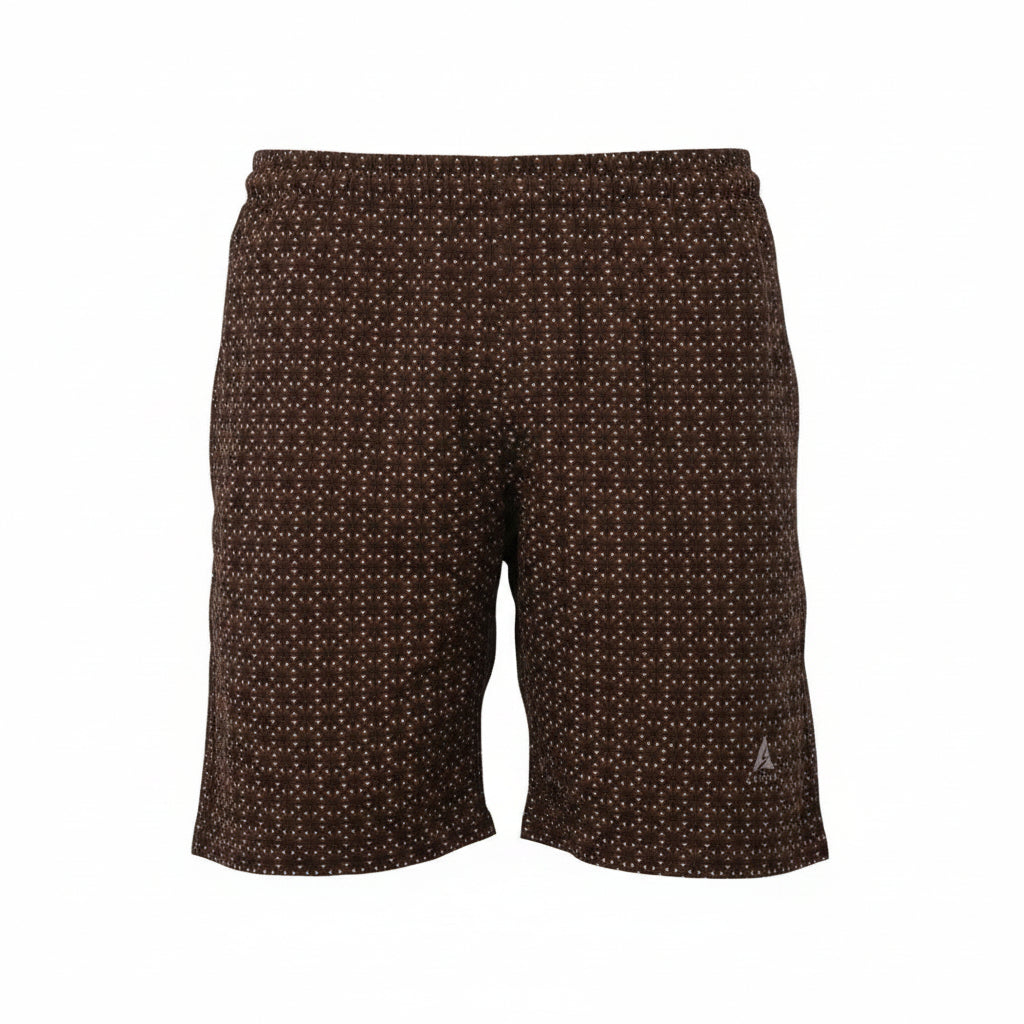 A professional ghost mannequin photograph of dark brown men's swim shorts featuring a dense white geometric micro-pattern. The shorts have an elastic waistband and a silver Blend logo on the thigh, set against a seamless white background. (Style: Ghost Mannequin view)